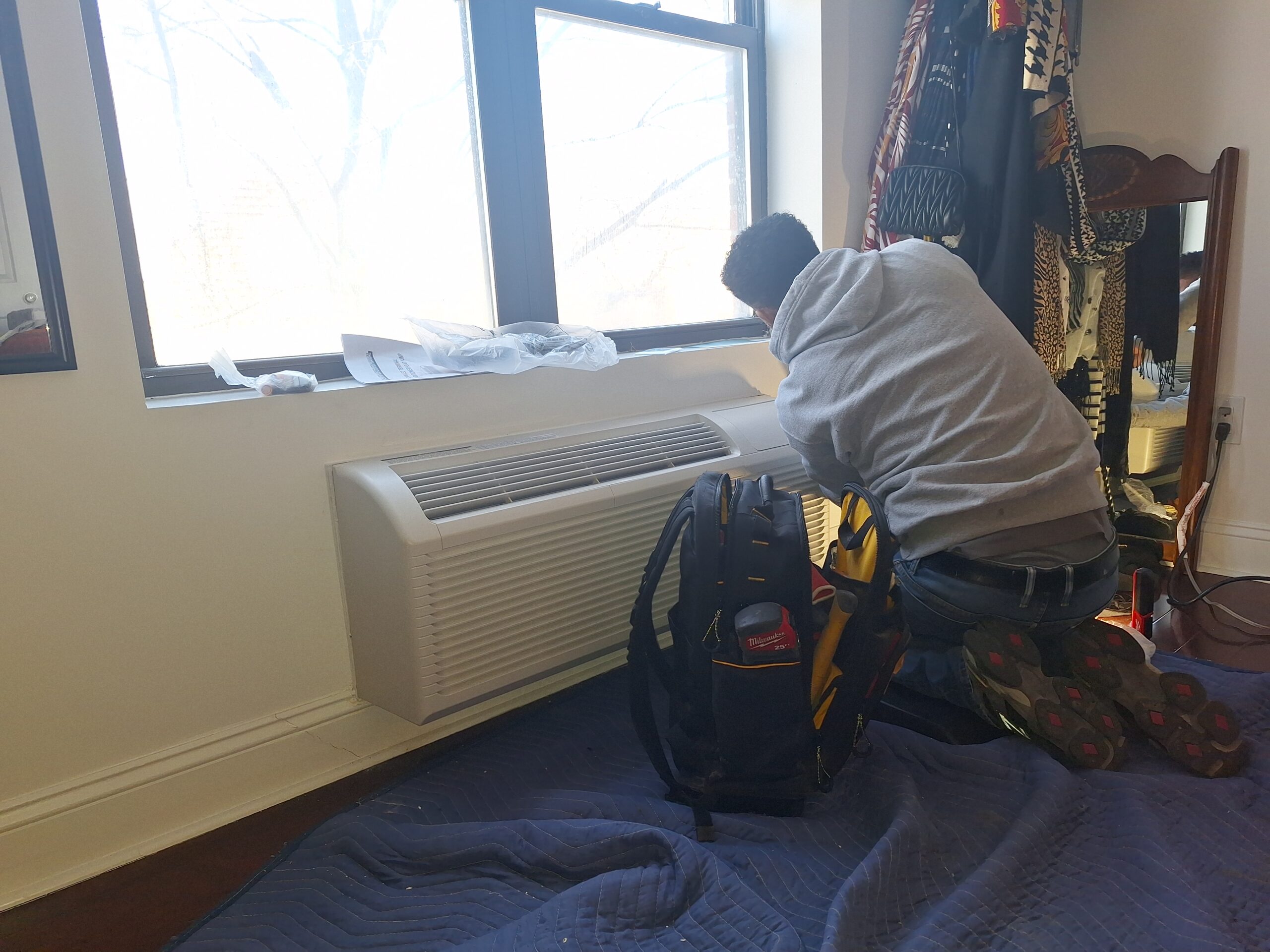Service Right technician servicing an HVAC system in Boston